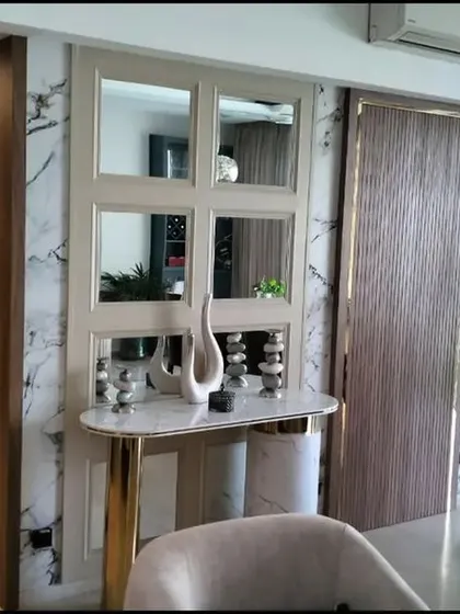 A wider view of the completed foyer, showing how the new main door and concealed utility doors create a cohesive and luxurious entryway.