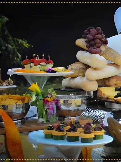 A delectable spread of appetizers, featuring a tower of fresh bread, cheese platters, and various canapés, showcasing the variety we offer.