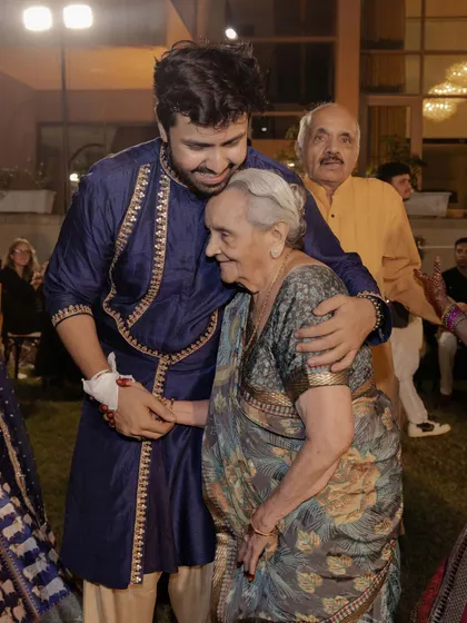 A heartwarming moment between the groom and his grandmother, a reminder that weddings are about family and generations coming together.