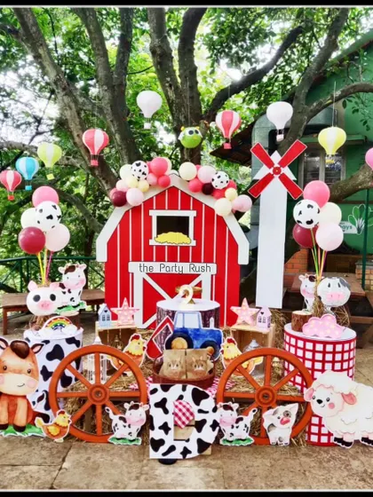 Welcome to the farm! This adorable barnyard-themed party features a red barn backdrop and cute cutouts of farm animals like cows, sheep, and horses. The outdoor setting and playful details made it a day to remember.