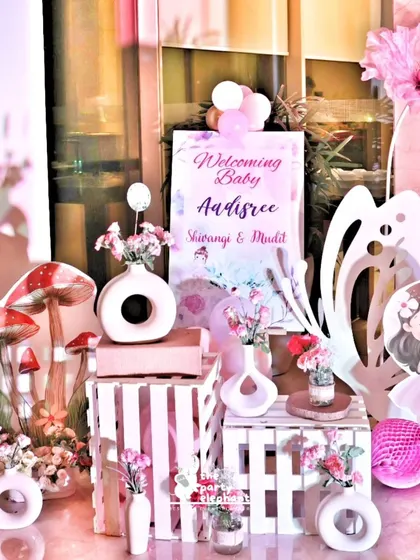 This charming welcome display for baby Aadisree features a collection of fairy-themed props. We used rustic wooden crates, modern ceramic vases, and cute character cutouts to create a beautiful and detailed entrance vignette.