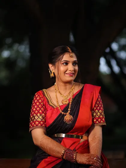 Deepika's elegant look for a pre wedding function. The classic red and black saree is paired with simple gold jewellery and a natural, glowing makeup look.