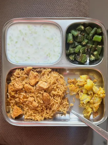 Another look at the delicious plate of chicken biryani with sautéed okra, potato, and cucumber raita.