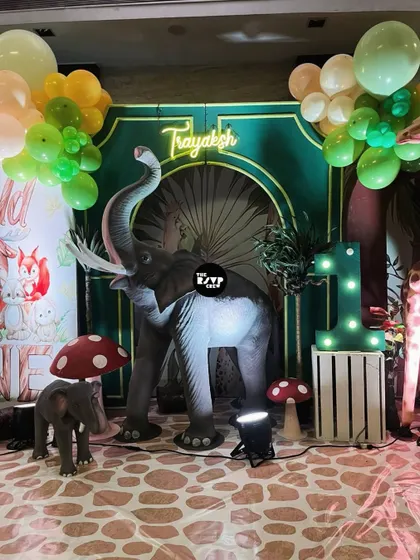 A close-up of the 'Wild One' backdrop, highlighting the large elephant prop and the lit-up number '1'.