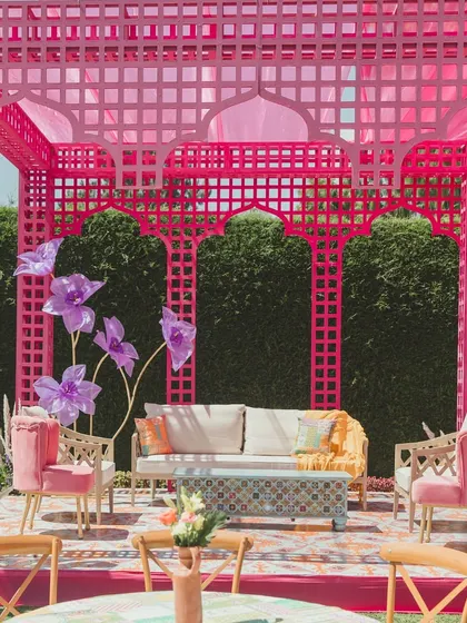 A chic lounge area with a pink jaali structure, providing a stylish and comfortable space for guests to relax.