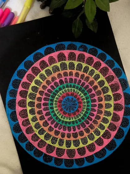 A hypnotic mandala with layers of colorful petals creating an optical effect. This piece is a great example of how geometric patterns can be used in meditative art.