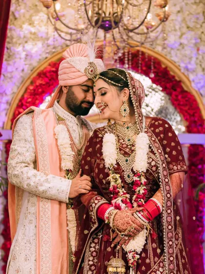 A romantic portrait of the bride and groom, their foreheads touching, after the wedding ceremony.