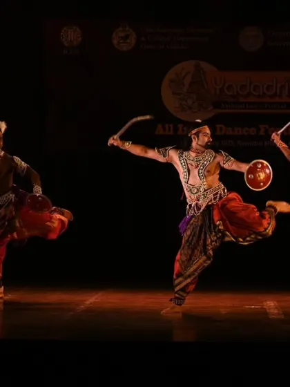 A dynamic, wide-legged stance from a Mayurbhanj Chhau piece. The dancers' movements are grounded yet fluid, reflecting the form's origins in martial training exercises.