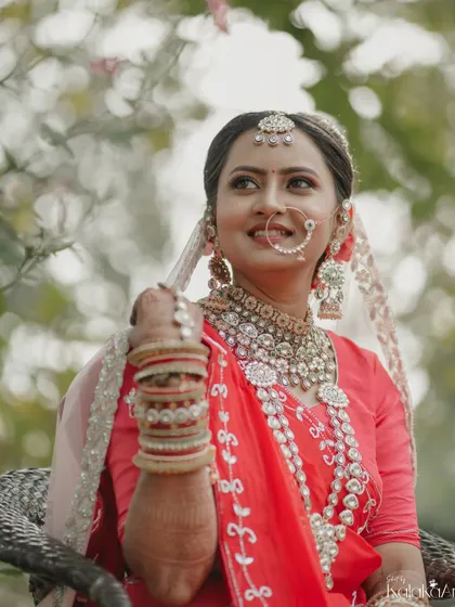 A beautiful outdoor bridal portrait. The bride's elaborate jewelry and serene expression are captured perfectly in the soft, natural light.