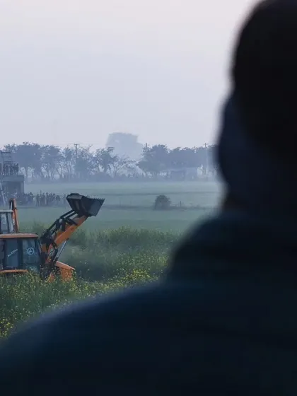 JCBs are brought in to help manage the area during the tiger rescue, a stark image of machinery in a supposed wildlife habitat.