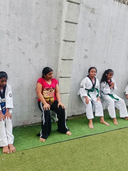 The wall sit. It looks simple, but it's a killer exercise for building leg strength and mental toughness. My students learn to push through the burn.