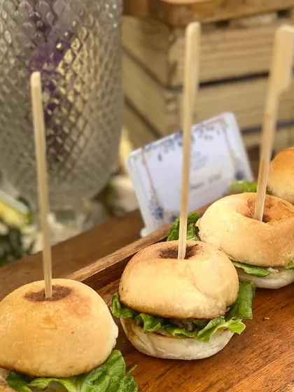 A close-up of our mini chicken sliders, a popular choice for winter lunches and casual parties. The soft buns, fresh lettuce, and savory patty make for a perfect bite-sized treat.