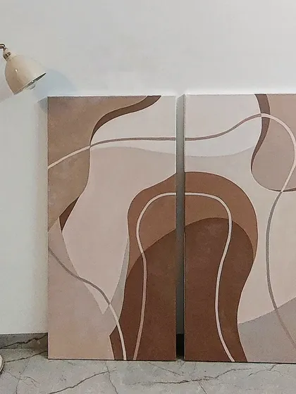 This two-piece canvas set, or diptych, explores form and color in shades of brown and beige. The continuous, flowing lines across both canvases create a unified and calming abstract artwork perfect for a modern home.