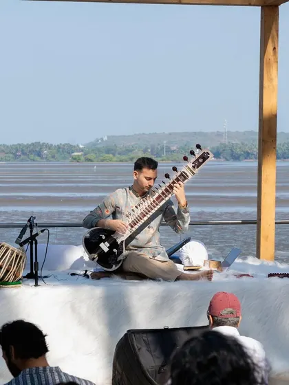 Performing by the sea in Goa. The natural sound of the waves combined with the sitar creates a uniquely calming experience, ideal for destination weddings or exclusive beachside events.