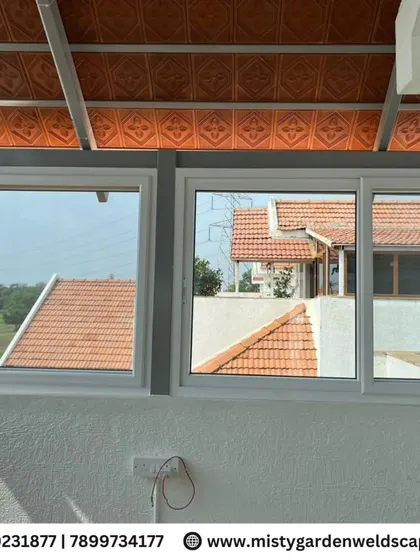 A detailed look at the sliding UPVC windows installed in a terrace room. These windows are easy to operate, durable, and provide excellent weather protection.