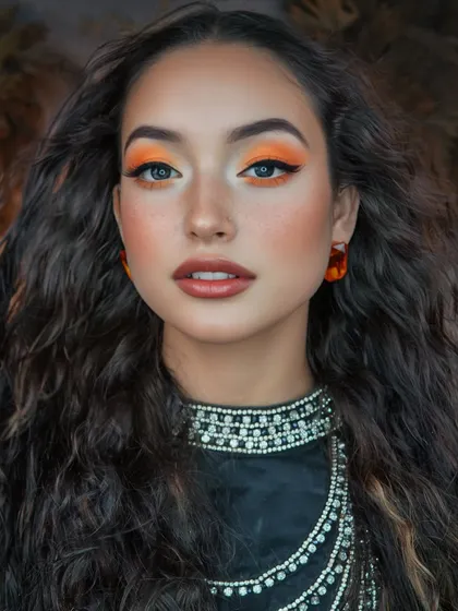 A fierce gaze with vibrant orange eyes. This creative look is perfect for editorial shoots or for someone who loves to experiment with color.