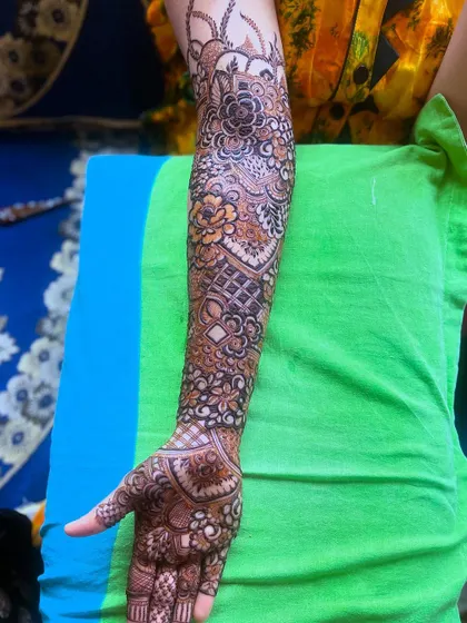 A single arm view of the bridal henna, highlighting the detailed work and beautiful flow of the design.