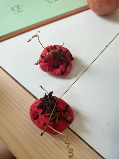The finished playdough creations from our apple-themed activity. The process of adding spices and twigs is just as important as the final product, allowing for rich sensory exploration.