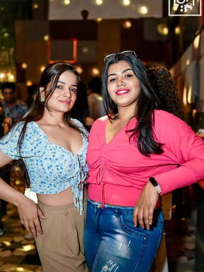 Two friends enjoying the festive atmosphere and getting ready for a night of dancing at LOFT38.