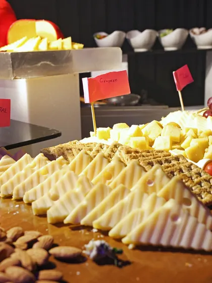 A close-up of our international cheese board, with a variety of cheeses, crackers, and nuts. This is a sophisticated and always popular choice for corporate events.