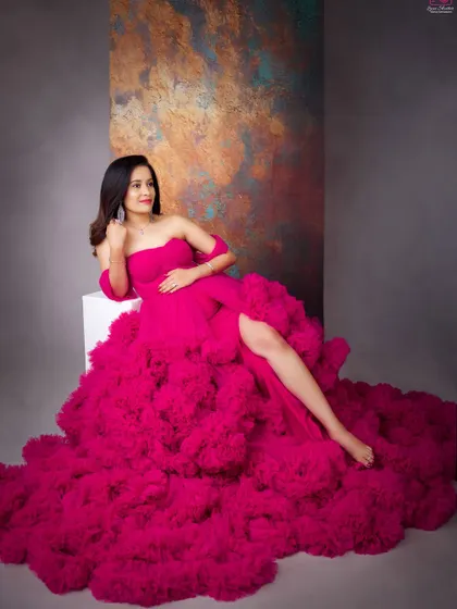 This portrait showcases the incredible texture and drama of the ruffled magenta gown. It’s a look that is guaranteed to make you feel like a star.