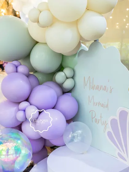 A detailed shot of the pastel balloon arrangement for the mermaid party welcome sign.