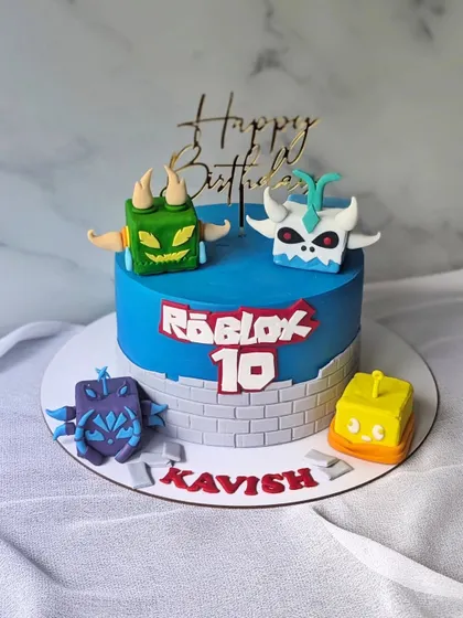 A Blox Fruits cake for a Roblox fan's 10th birthday. This vibrant blue cake is decorated with the Roblox logo and several characters from the popular game.