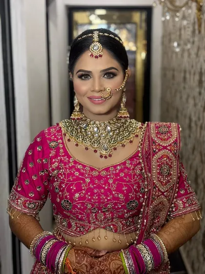 A happy bride showcasing her final look. The smile says it all. The makeup is set to last all day, ensuring she looks fresh and radiant throughout the celebrations.