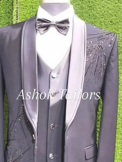 A grey three-piece tuxedo with unique feather-like sequin embroidery. This is a great choice if you want a modern, artistic design for your special occasion.