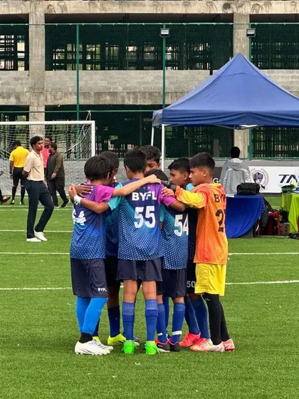 A team huddle showing unity and focus during the TAL Youth League match.