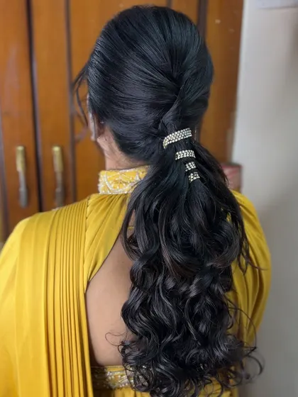 A chic and modern ponytail with beautiful curls, accessorized with rhinestone bands. A great style for a party look.