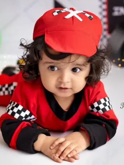 A close-up on this adorable racer's face. His beautiful curly hair and big brown eyes are just captivating.