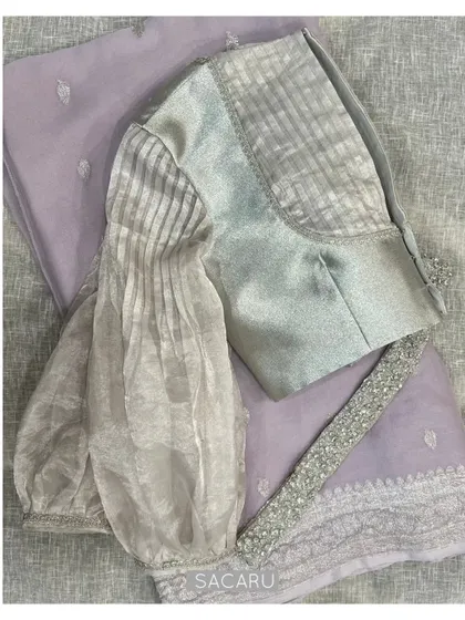 Another view of our silver blouse with pleated organza sleeves, a design that is anything but average.