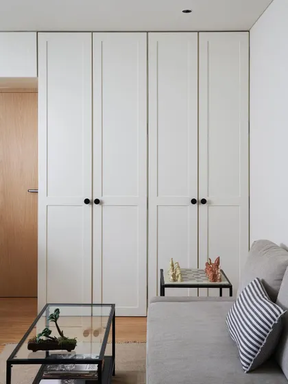 The drawing room at Zen House features simple, clean lines with classic shaker-style wardrobe doors and a comfortable sofa bed, ensuring the space is both elegant and highly functional.