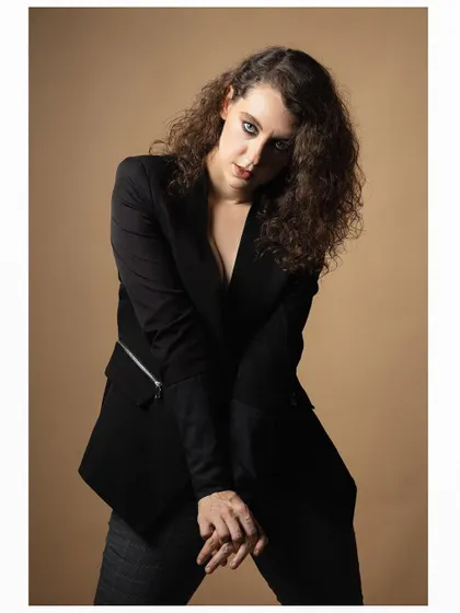 A more introspective pose from the same session. The model's posture and gaze create a sense of mystery and depth, showing her versatility.
