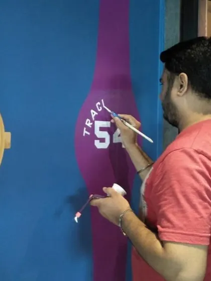 Here you can see me adding the fine details to a watch mural. Every part of the process is done by hand with a fine brush to ensure the final artwork is sharp, accurate, and truly a piece of custom art.