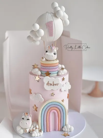 A dreamy first birthday cake combining unicorns, rainbows, and a hot air balloon. Learn to create multiple popular elements in one cohesive and adorable design.