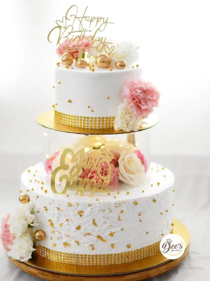This floating tier cake creates a stunning illusion for a birthday or engagement. The clear acrylic separator adds a modern touch, while the gold accents and fresh carnations keep it elegant and celebratory.