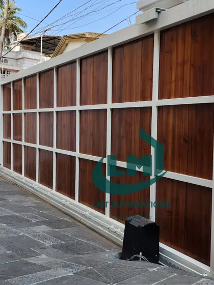 The completed installation of a large, wood-paneled cantilever gate. The powerful motor and robust hardware ensure it operates smoothly despite its size and weight.