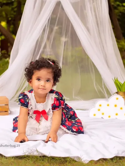 A beautiful toddler portrait taken during an outdoor canopy session, creating a dreamy, bohemian feel.
