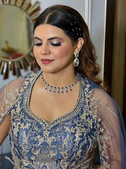 A side view of the makeup, highlighting the cheekbones and the elegant hair accessory.