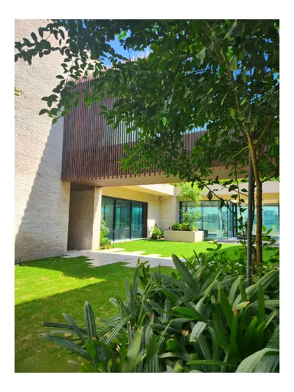 The courtyard of our Dubai Hills villa, Wahatan. The home is designed as an oasis, with lush greenery and a bridge connecting two wings, creating a private, natural world in the middle of the city.