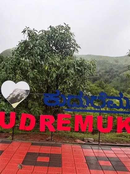 A group of friends at the "I Love Kudremukh" sign, a classic photo spot.