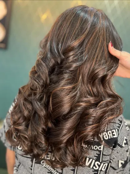 Bringing the cocoa vibes to life with this chocolaty hue. The deep, rich color is styled into beautiful, bouncy curls.