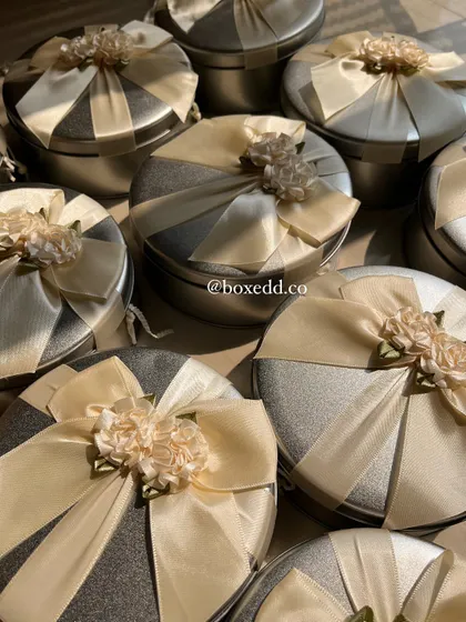 A collection of our elegantly wrapped return gift tins. The consistent, beautiful presentation ensures every guest feels equally appreciated.