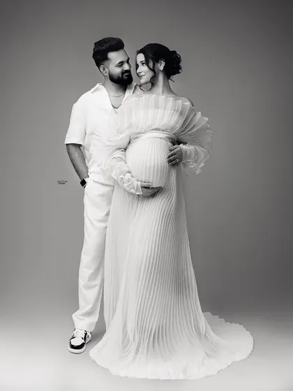 The same loving pose in timeless black and white. This edit really emphasizes the emotional connection and the beautiful textures of their outfits.