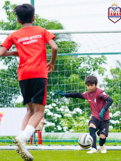 A young goalkeeper makes a crucial save in a one-on-one situation.