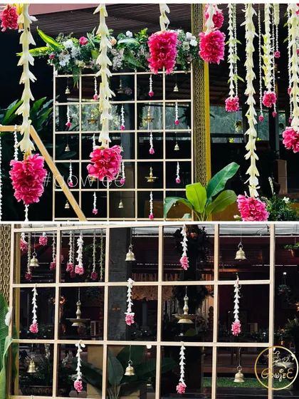A close-up of the intricate hanging decor, featuring pink flowers, bells, and traditional elements.
