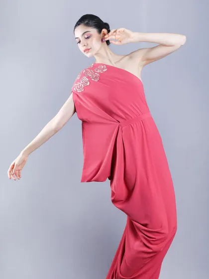 A full-length shot with a dynamic pose, illustrating how the draped fabric of the dress moves, providing a sense of motion for a lookbook.
