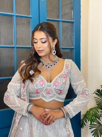 A beautiful pastel lehenga with pink and blue floral embroidery. This rental is a dreamy choice for a sangeet or engagement.